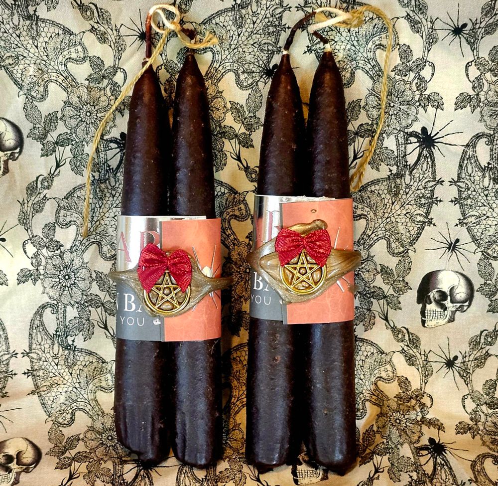 Dark brown hag stick style candles with "Turnback while you can" wrap with gold wax and pentacles and maroon bows