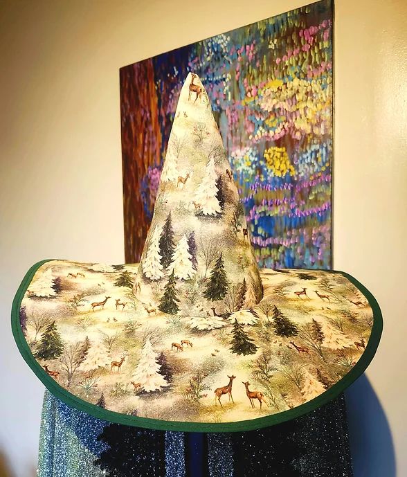 Witch hat made of shimmer quilt grade cotton featuring winter landscape and critters