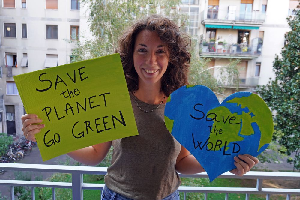 A woman with pro-environmental signs. Stock photo.   