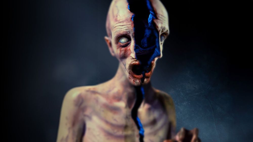 Visuel de Terrified, représentant un homme livide, nu, malingre et aux yeux révulsé, dont le corps se sépare selon une coupe longitudinale pour révéler une crevasse de ténèbres.