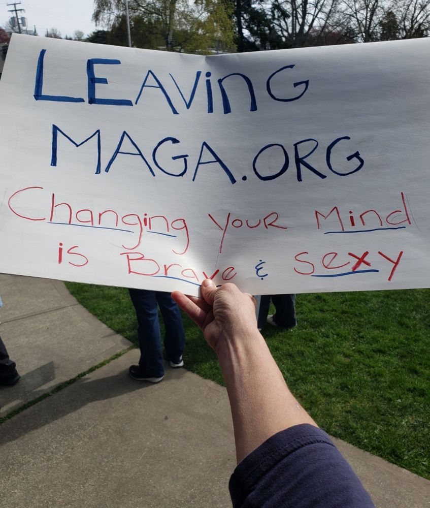 Picture of person holding sign that reads: leavingmaga.org changing your mind is brave & sexy