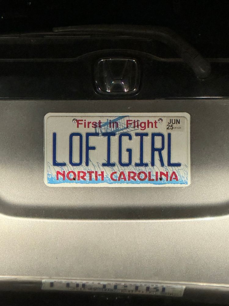 NC license plate LOFIGIRL on a silver car. don’t doxx my little brother he’s the best dude, who wisely says license plates are like lower-commitment knuckle tattoos 