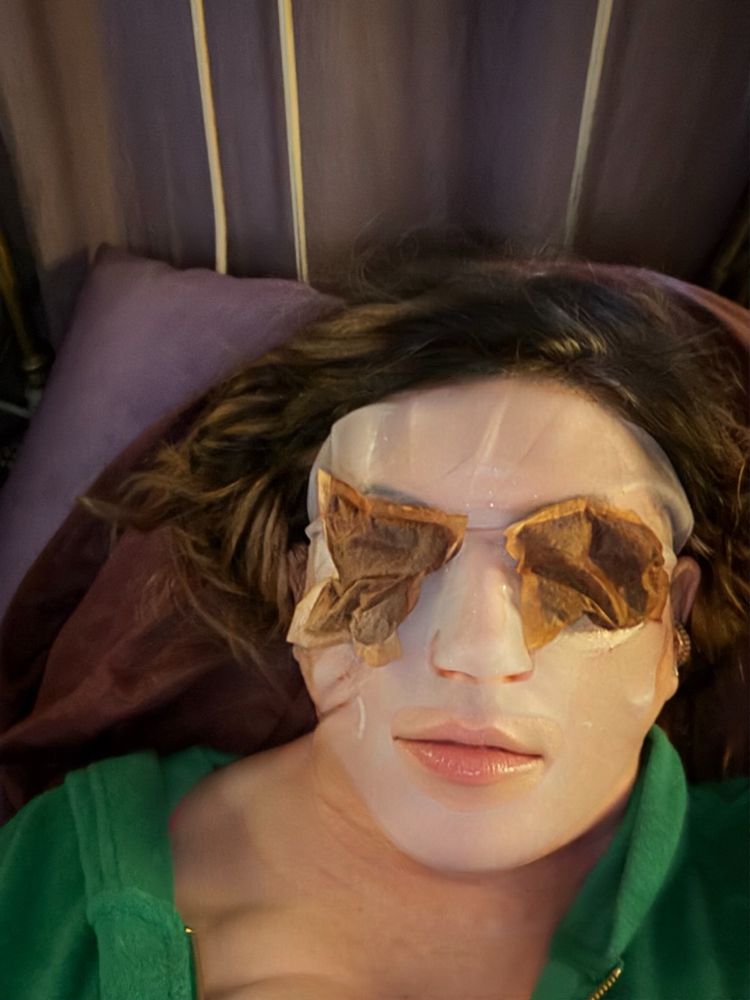 Hyper-moisturizing and depuffin' for that bouncy skin of youth! Same woman… Teabags on eyes, white silicone mask, and a green terry cloth hoodie.