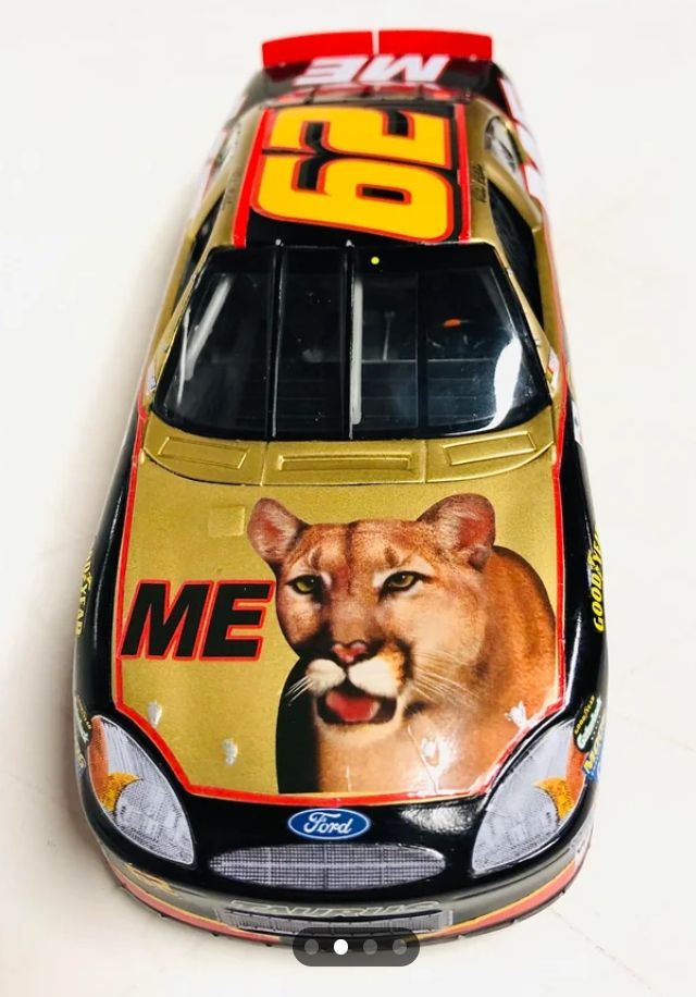 Ricky Bobby's car from Talladega Nights - a yellow and red Ford with a cougar on the hood and the words ME
