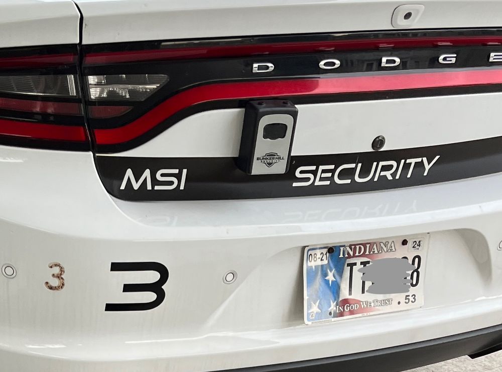 Rear of a vehicle with an expired tags part of the tag number is marked out
