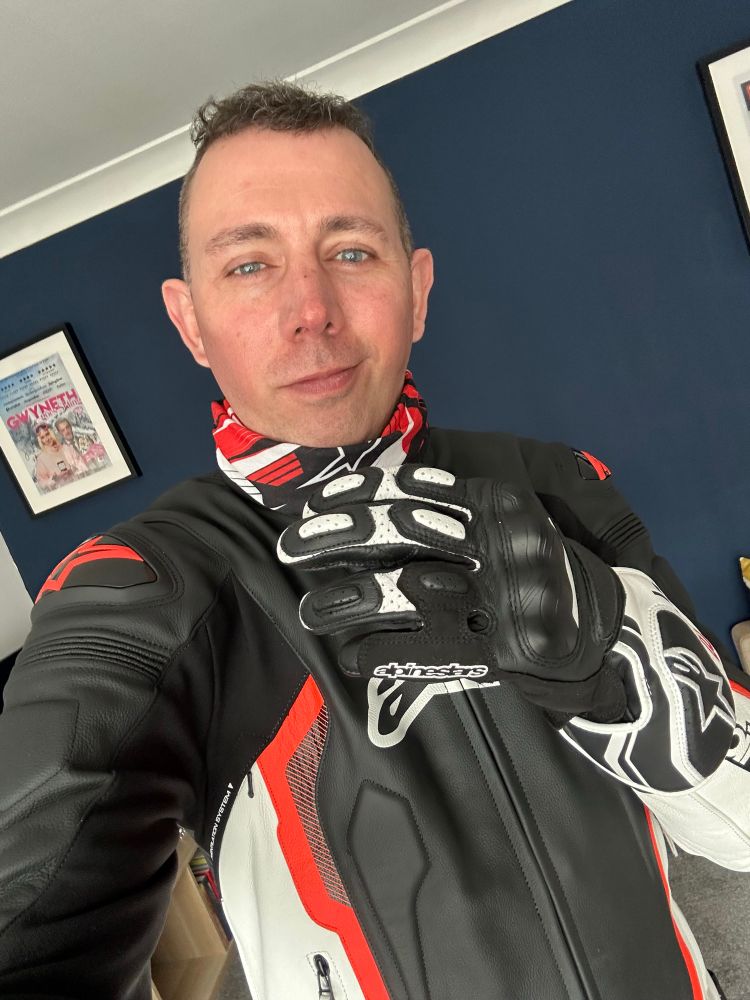 Badly tanned guy in new leather jacket feeling his oats. Showing gloves so you can hear the photo leather creek 