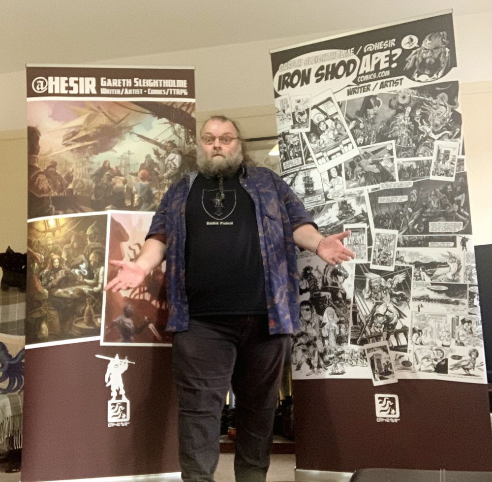 Me stood in front of my new event banners. It's been nearly a decade since I had the last one done, so it's about time, and at least this time they show off the art a little better and it even looks like I admit to doing colour work too!