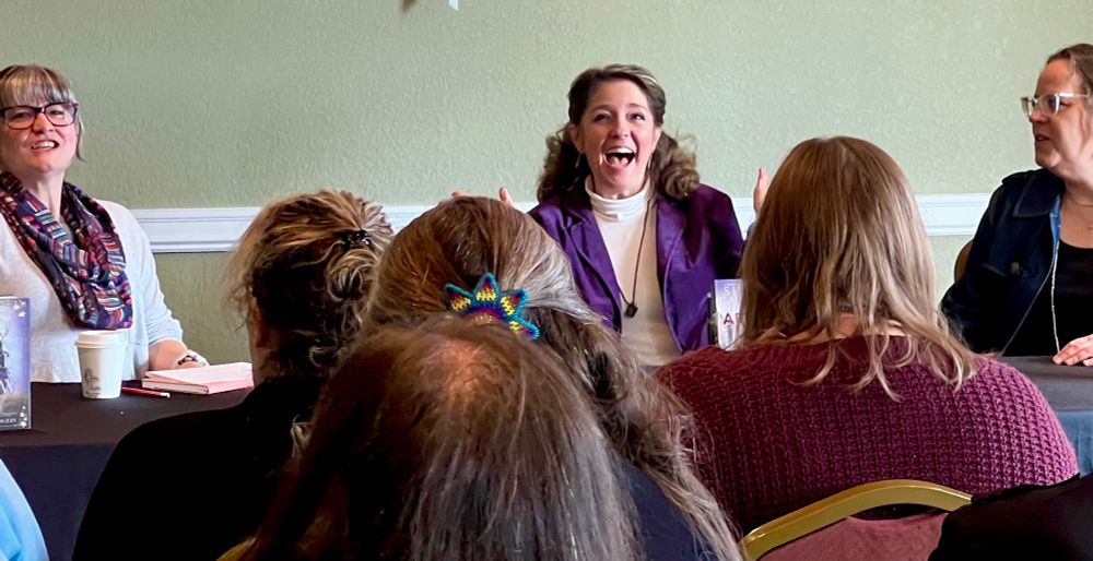 Sharon Cameron and panelists laughing during the author panel. 
