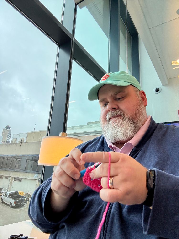 A photo of me crocheting while waiting at the airport