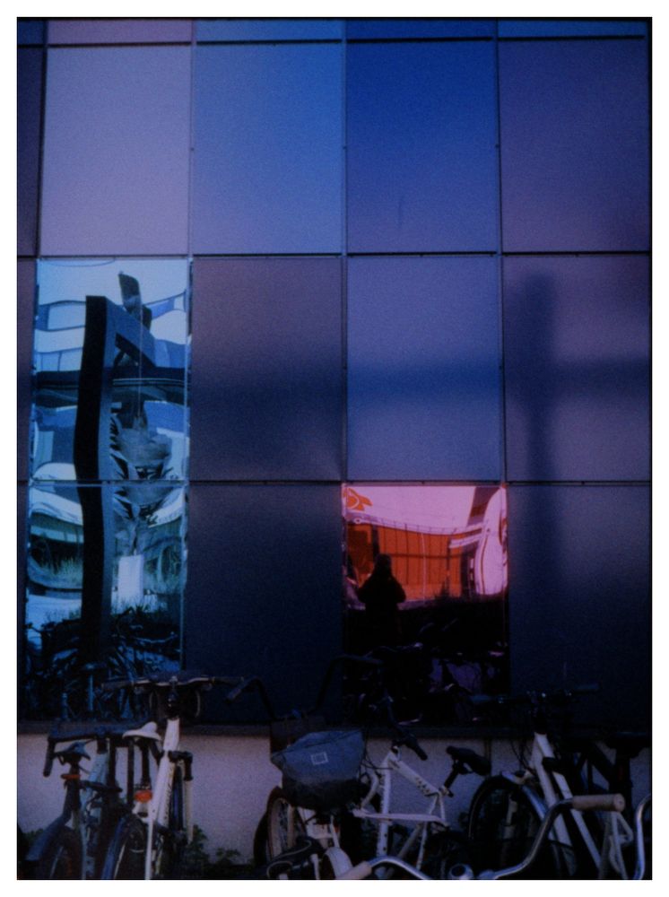 The semi-mirrored wall of the Tampere Central Hospital. Some bikes on the foreground.