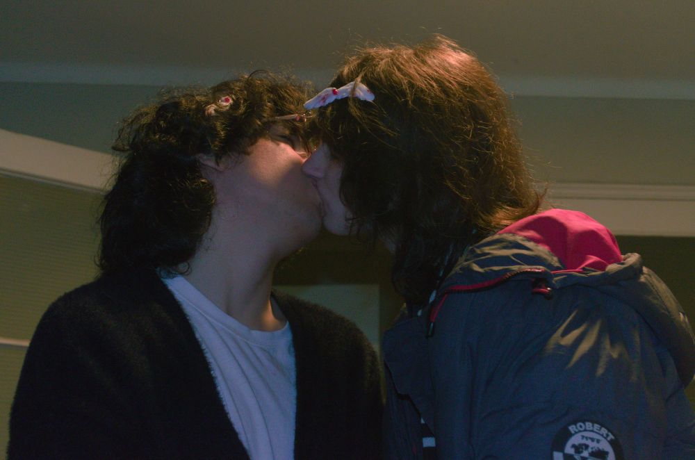 A photo of me kissing my girlfriend. Both of us are using matching hair clips.
