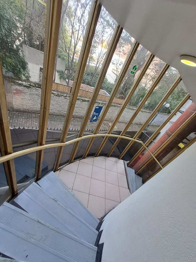Stairs on the same mall. They go in a spiral, and have window that curves around them.