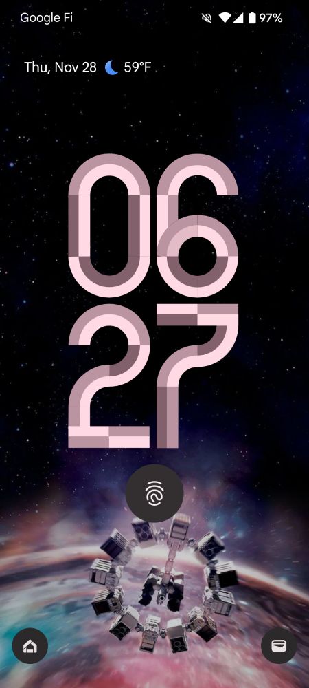 Android Lock screen with large mauve numbers over a black space background with stars fading to the spacecraft from the movie Interstellar in orbit around the black hole