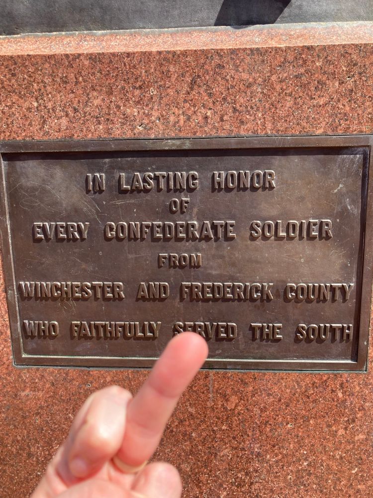 Photo of user putting their middle finger up towards a memorial plaque for “fallen” confederate soldiers 