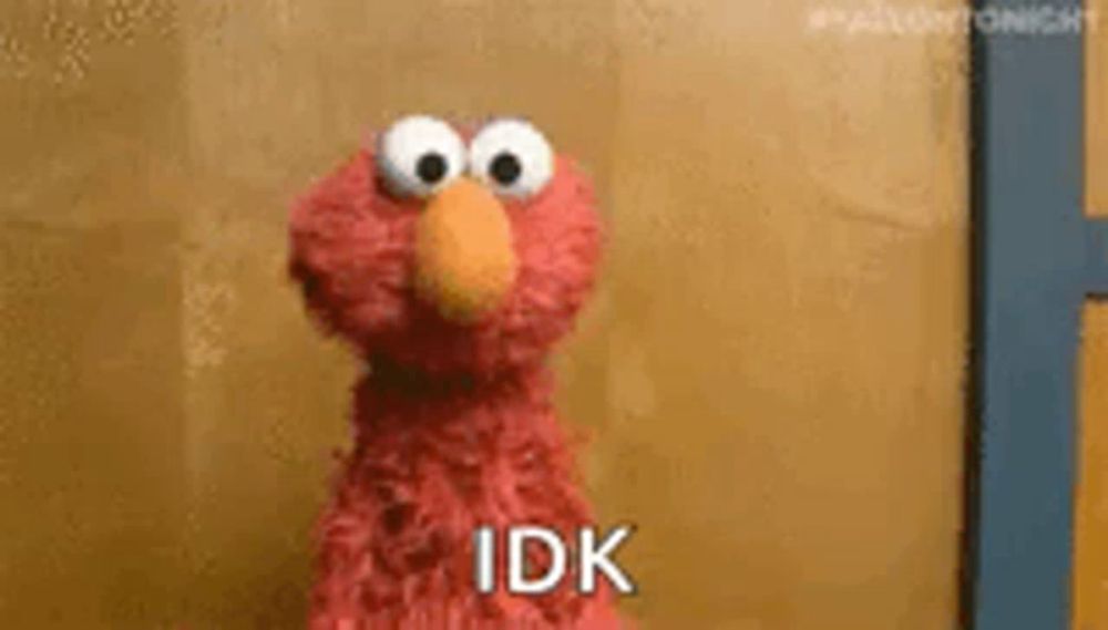 elmo from sesame street is standing in front of a yellow wall and says `` idk '' .