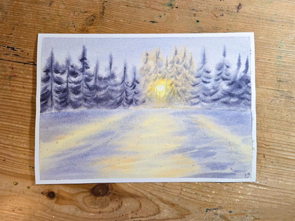 A watercolor landscape of a winter scene. There is a row of pine trees in the background, and the sun is peeking through just right of center. The foreground is a flat snowy area, alternating between sunlight and shadow. The overall color is muted lavender, with a purple-gray for the pine trees and orange-yellow for the sunshine and trees that are backlit by the sun.