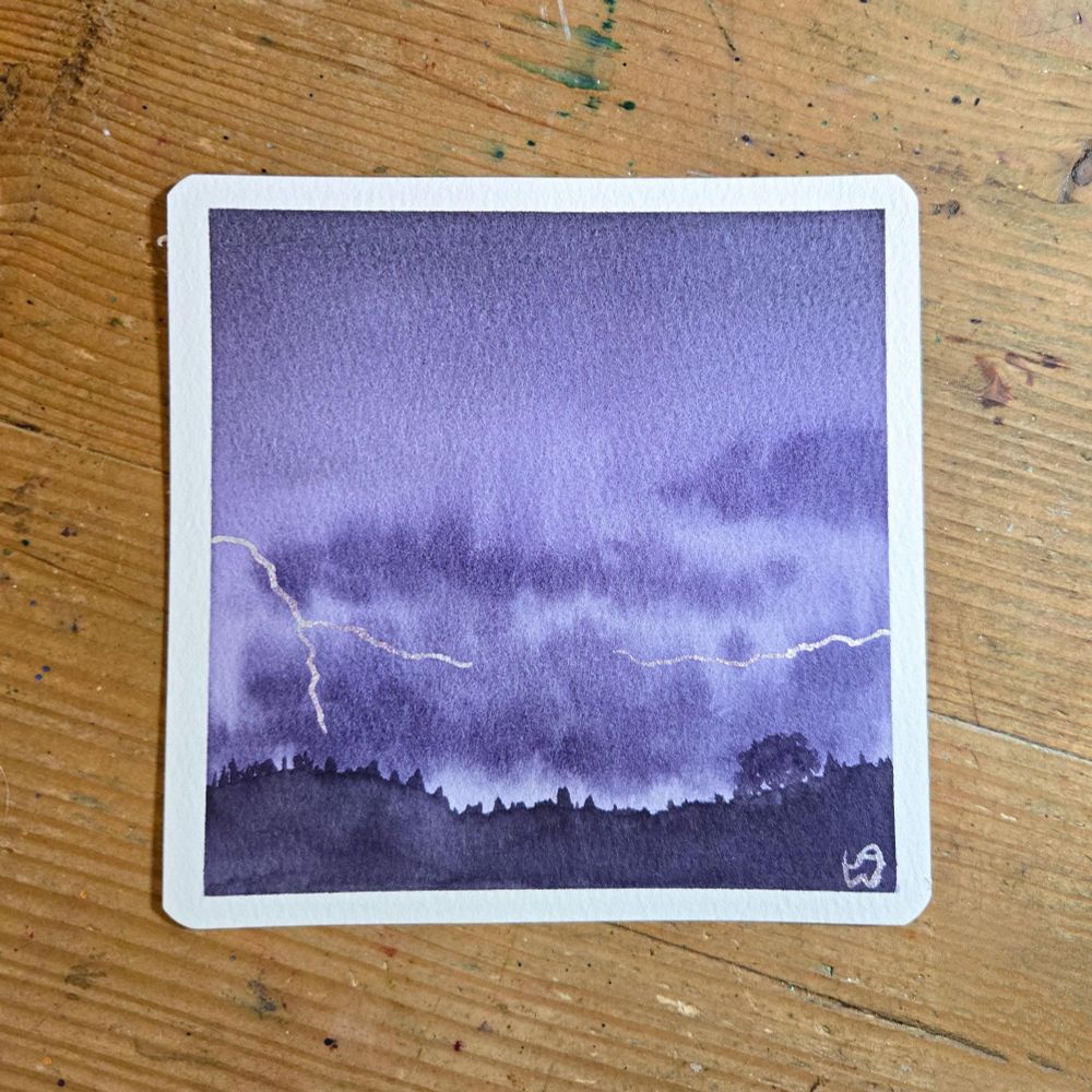 A watercolor painting of a thunderstorm. The entire painting is shades of purple, with dark clouds hanging over some hills in the distance. Lightning flashes on the left and right sides using shimmery paint. 