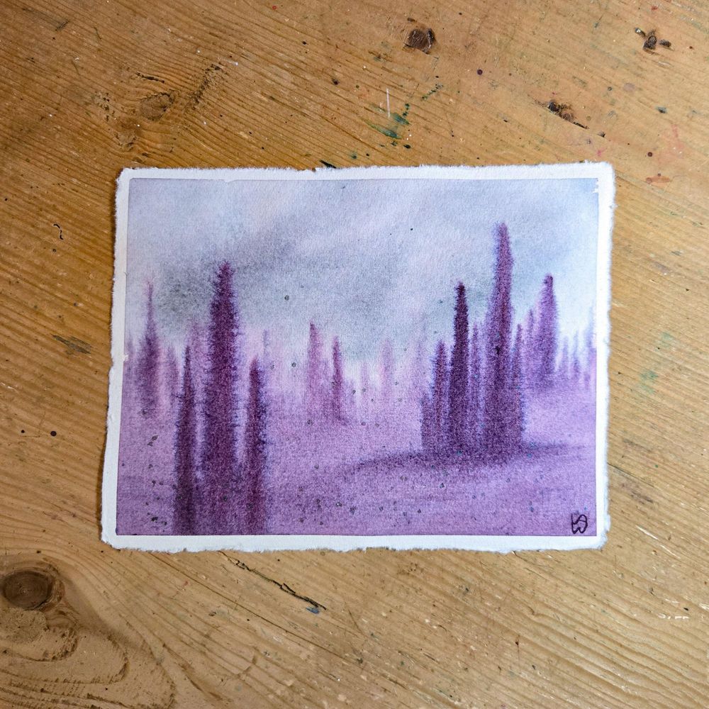 A watercolor painting of an abstract forest. The sky is gray with some dark clouds and there are purple tree-like figures that are long and thin and a little creepy. There is a treeline in the background, and a couple clusters of these trees in the foreground. The ground is the same color of purple. 