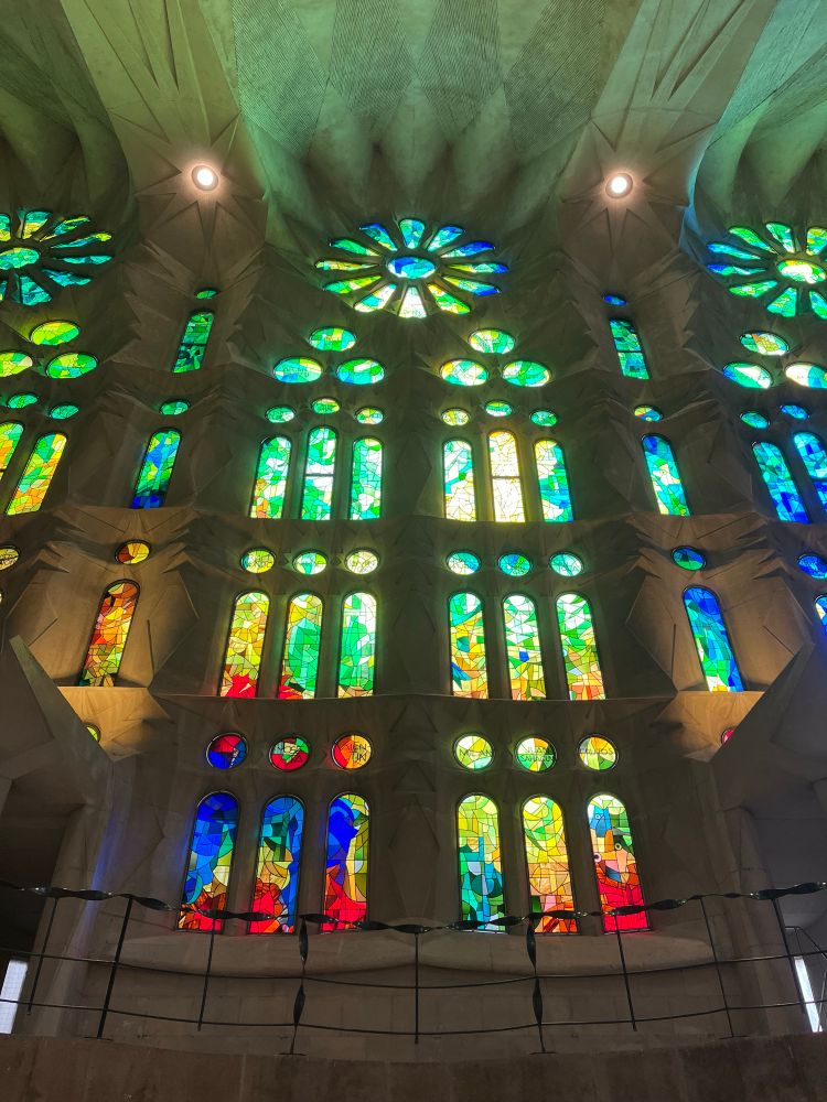 Colorful stain glass windows let light into a church.