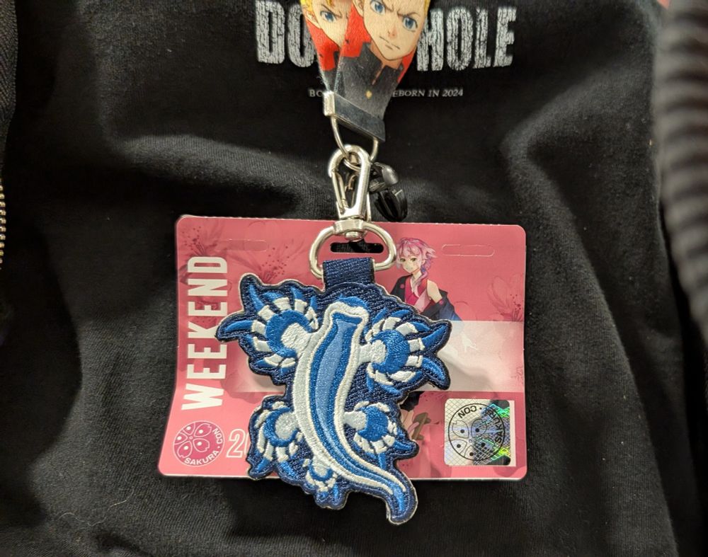 A blue glaucus nudibranch embroidered badge on my name badge