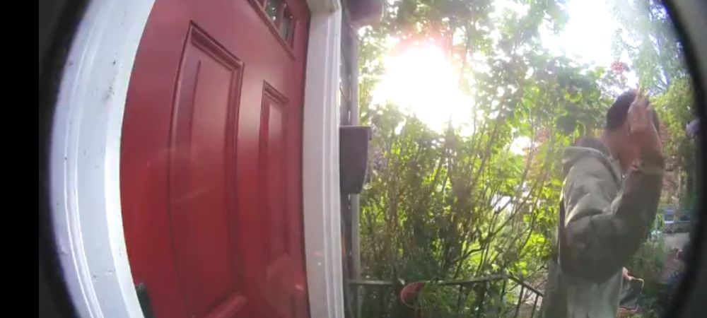A doorbell camera still of a guy leaving with his hand thrown up