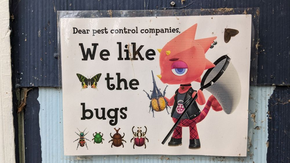 A sign by my front door that says "dear pest control companies, we like the bugs" and it features flick, a pink chameleon, from animal crossing, along with several bugs from the game