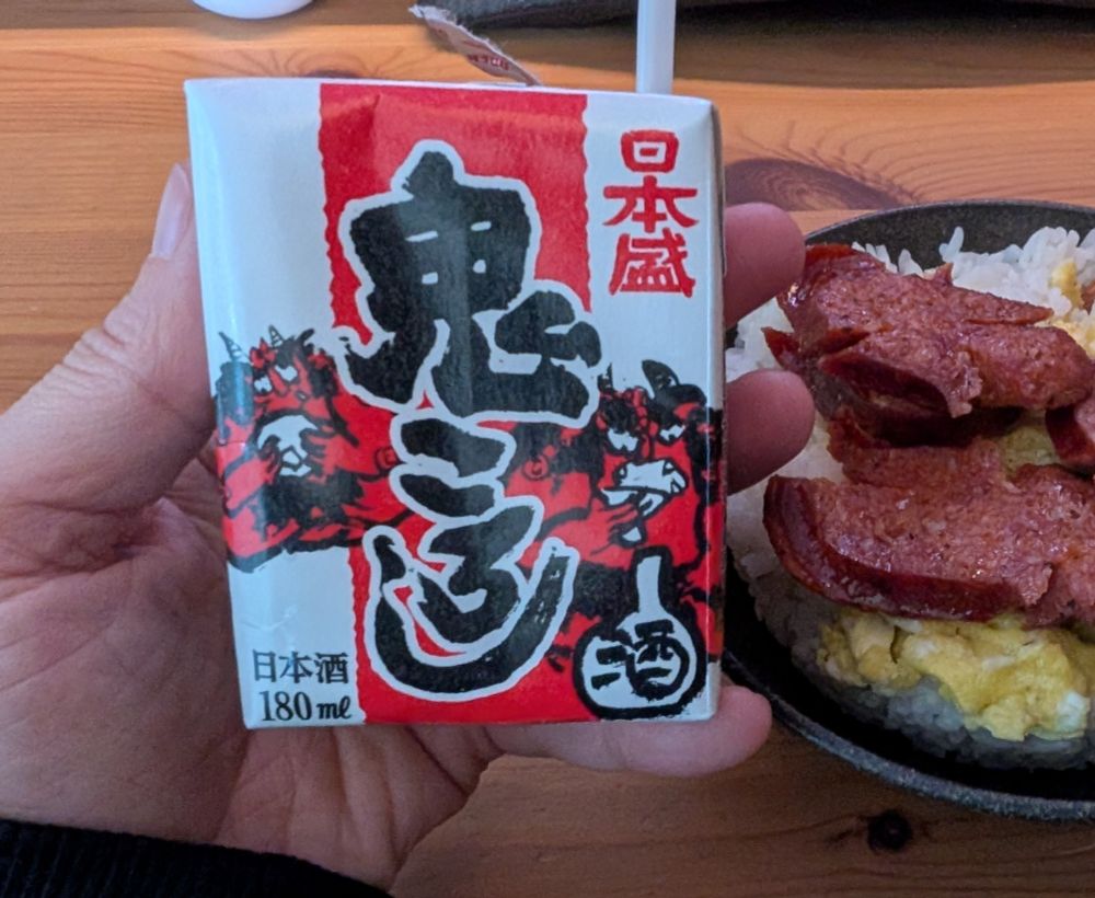 Tiny juice box size sake with oni illustrated on the box