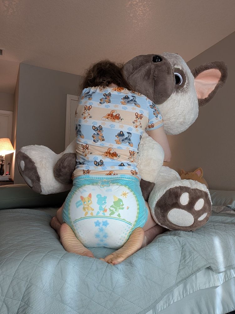 Me hugging my Frenchie stuffy in a soaked tryagains and heelerpup onesie from ODU