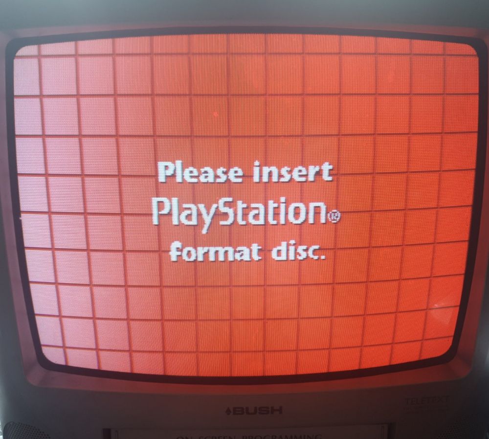 Pleasse insert PlayStation format disc - white text on an ominous gradient red grid pattern background on a crt tv.
