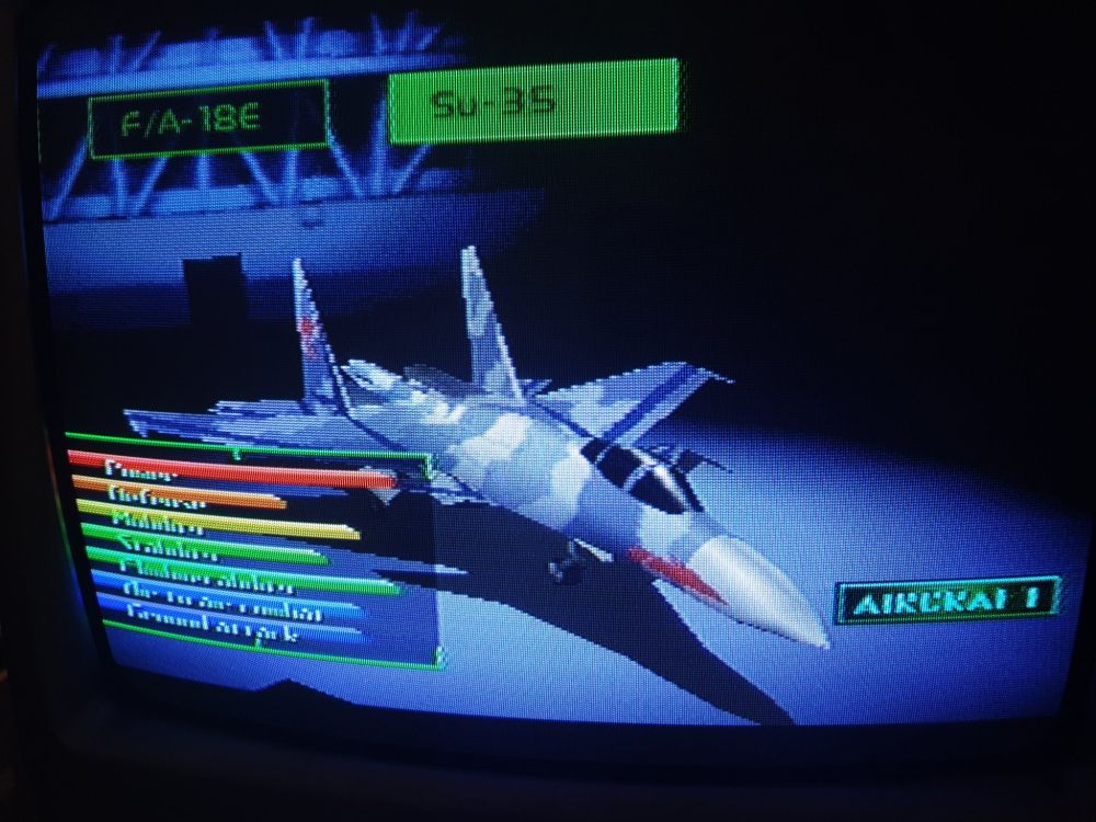A CRT screenie of a 3D polygonal Su-35 in greyish blue-white camo livery with its own stats displayed.