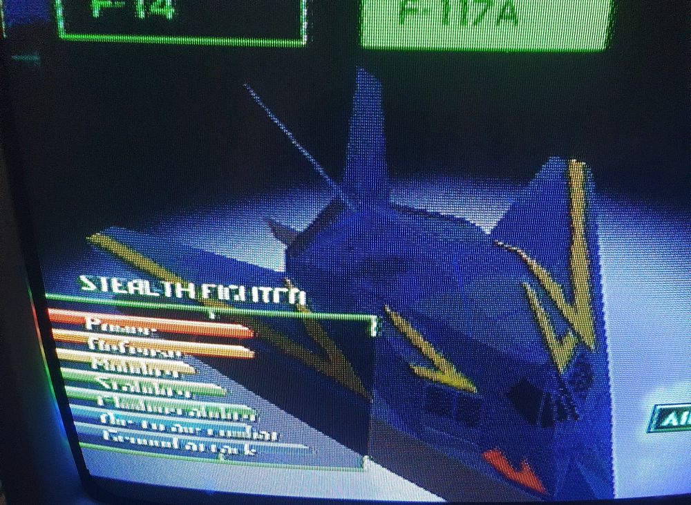 A CRT screenie of a 3D polygonal F-117A stealth fighter in blue-black livery with yellow markings.