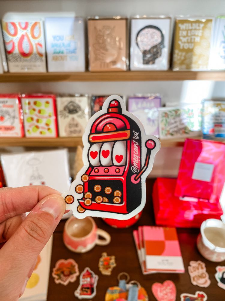 A sticker of a slot machine showing hearts