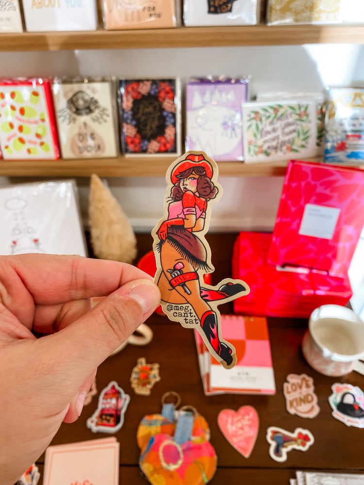 A sticker of a pin-up cowgirl