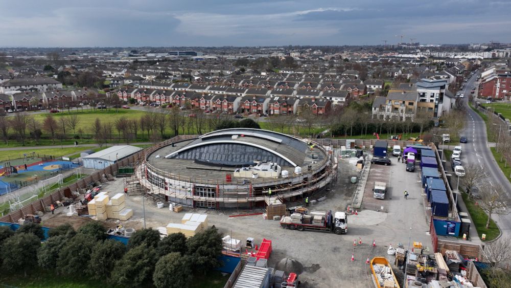 Works are progressing at the spectacular Baldoyle Community Centre and Racecourse Park Carpark.

Completely funded by Fingal County Council through its Community Development & Parks & Green Infrastructure Departments.

When constructed, the Baldoyle Community Centre will prioritise sustainability and accessibility and will have a green roof and rain-garden to promote biodiversity and ecology.

The circular design will minimise visual disruption to the surrounding area and there will be ample bike parking to encourage the use of sustainable transport. There will also be accessible parking and electric vehicle charging points.

The central sports hall will have three courts and the overall complex will have four multi-purpose community rooms as well as externally accessible sports rooms for use by the likes of Baldoyle United FC, Na Dubh Ghall GAA Club and Suttonians Rugby Football Club who use pitches in Racecourse Park.

Find out more at www.fingal.ie/news/construction-baldoyle-community-centre-under-way