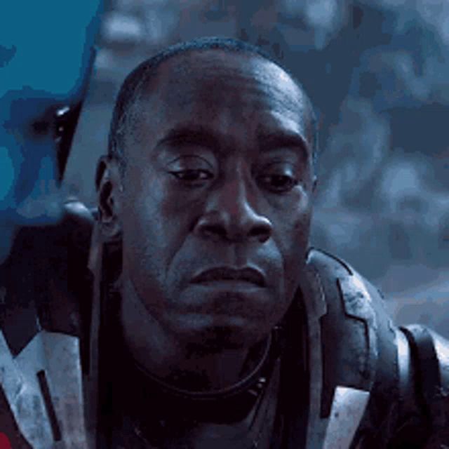 a close up of a man 's face wearing a helmet and looking at the camera .