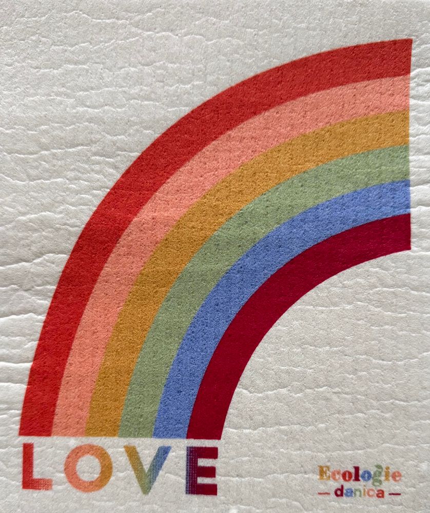 A rainbow-like image with the word "LOVE" in varying shades, printed on a dish cloth. The rainbow is divided into stripes of different colors that are uncannily not like a rainbow: red-orange, salmon, ochre, sea-green, cyan, and maroon, in order from the outside to the inside.