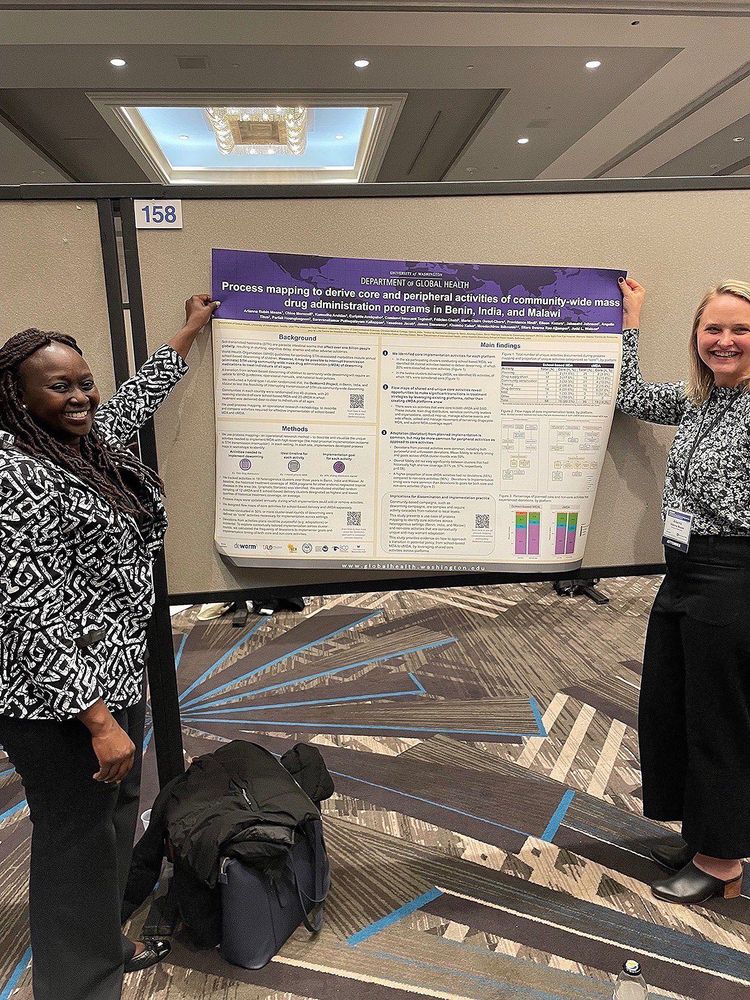 Sarah Masyuko and Arianna Means in front of their research poster at #DIScience24