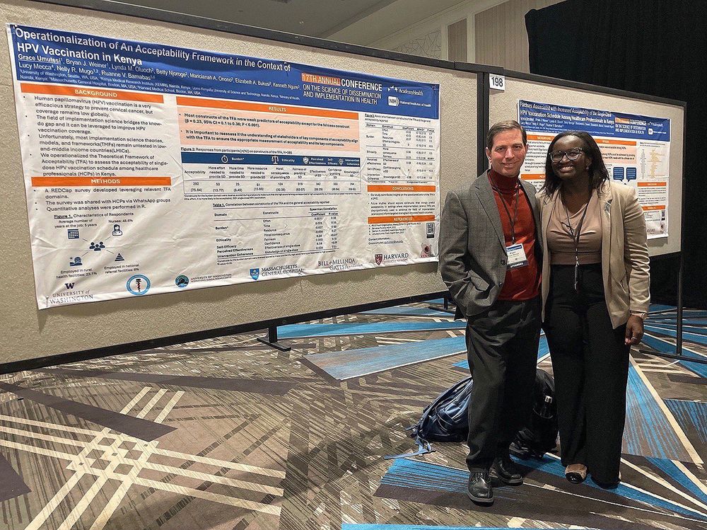 Bryan Weiner and PhD student Grace Umutesi stand in front of Grace's research poster at #DIScience24