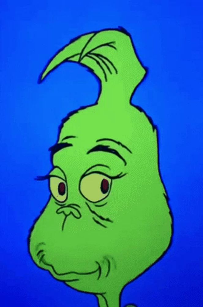 a close up of a green cartoon character 's face with a blue background .