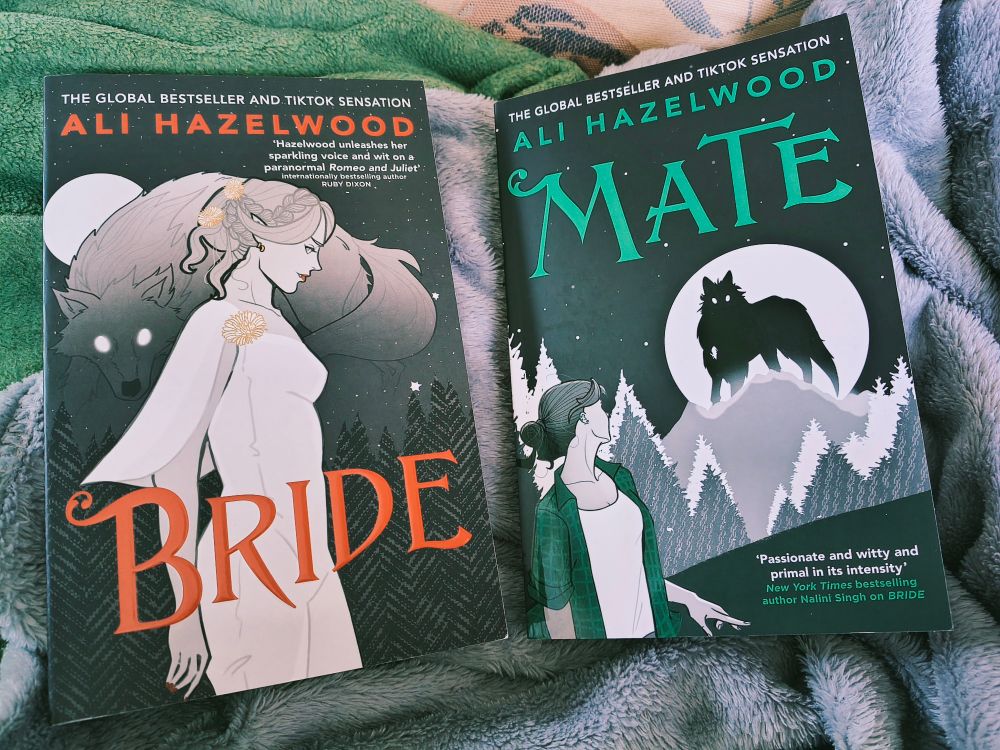 Bride and Mate by Ali Hazelwood next to each other on my couch