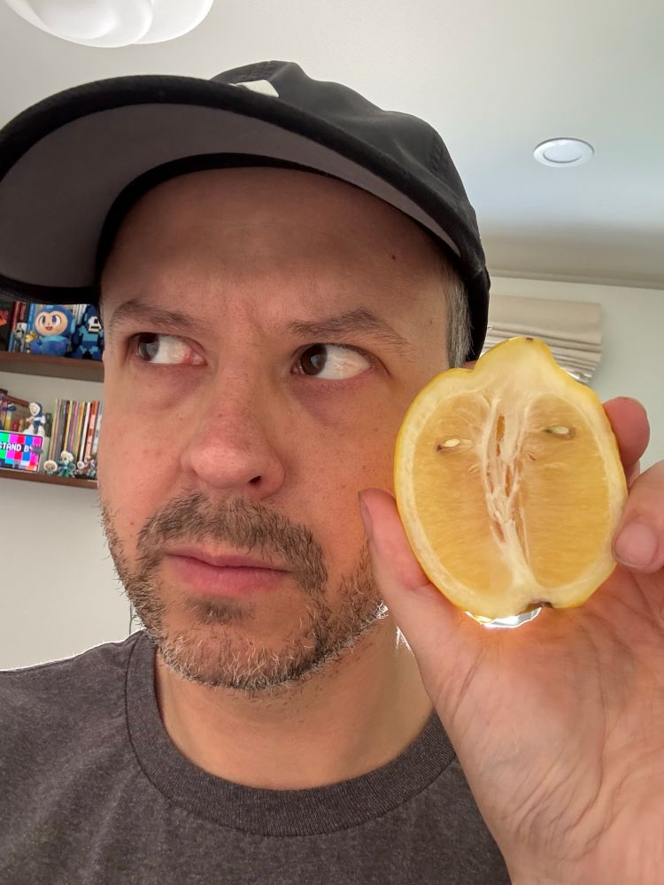Me, Daniel Kibblesmith, holding same lemon and making similar eye movement.