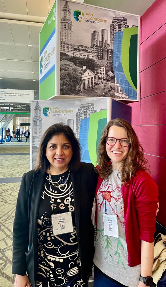 Two women child neurologists at AAN 2023. Neurons on a tshirt