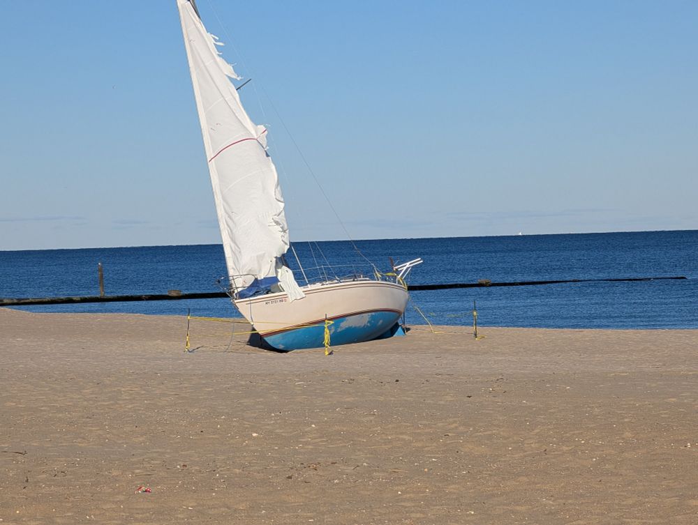 Sailboat washed up on a beach 