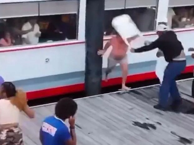 Man with a folding chair whacking down racist white man during the Montgomery Riverfront brawl