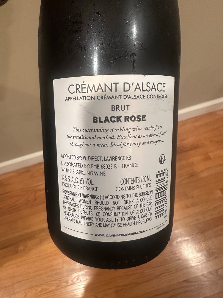 Back of the wine bottle.

Scanned: “CRÉMANT D'ALSACE
APPELLATION CRÉMANT D'ALSACE CONTROLÉE
BRUT
BLACK ROSE
This outstanding sparkling wine results from the traditional method. Excellent as an aperitif and throughout a meal. Ideal for party and reception.
IMPORTED BY: W. DIRECT, LAWRENCE KS ELABORATED BY: EMB 68023 B - FRANCE WHITE SPARKLING WINE
12.5% ALC. BY VOL.
CONTENTS 750 ML
PRODUCT OF FRANCE
CONTAINS SULFITES
GOVERNMENT WARNING: (1) ACCORDING TO THE SURGEON GENERAL, WOMEN SHOULD NOT DRINK ALCOHOLIC
7×L820,
9496
BEVERAGES DURING PREGNANCY BECAUSE OF THE RISK
WWW. CAVE-BEBLENHEIM.COM”