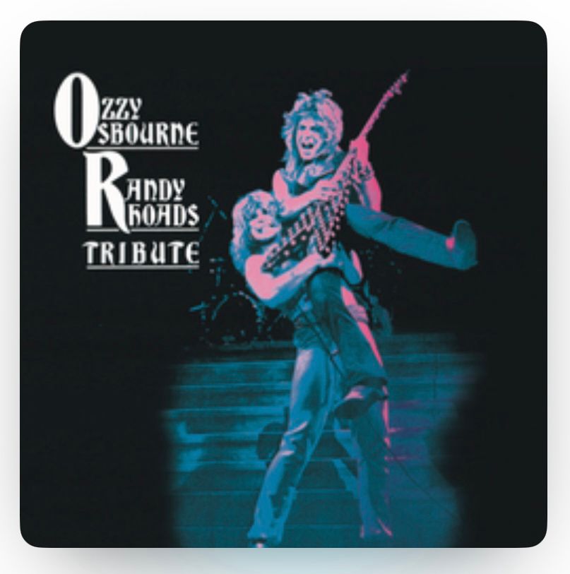 Album cover of Ozzy Osbourne - Randy Rhoads Tribute.

A young Ozzy Osbourne lifting Randy Rhodes playing guitar in a purple/blue hues