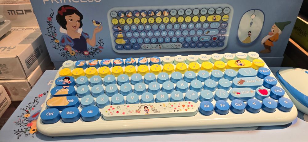 It's a Disney snow white themed keyboard with dark blue function keys the alphabet is light blue and the number pad is yellow.

The seven dwarfs are oddly f1-7