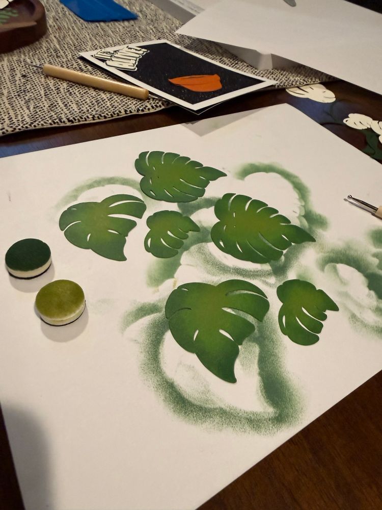 Paper monstera leaf cutouts shaded with distress oxide.