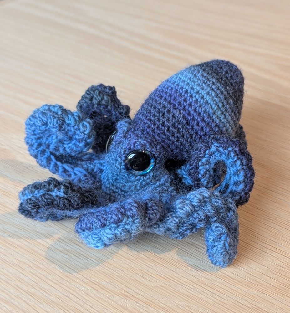 A crochet octopus in blue stripes.