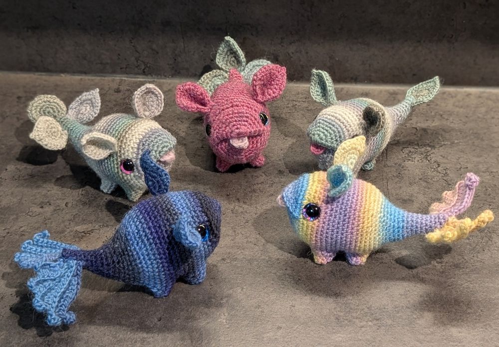 Five small droplet shaped monsters in a circle.